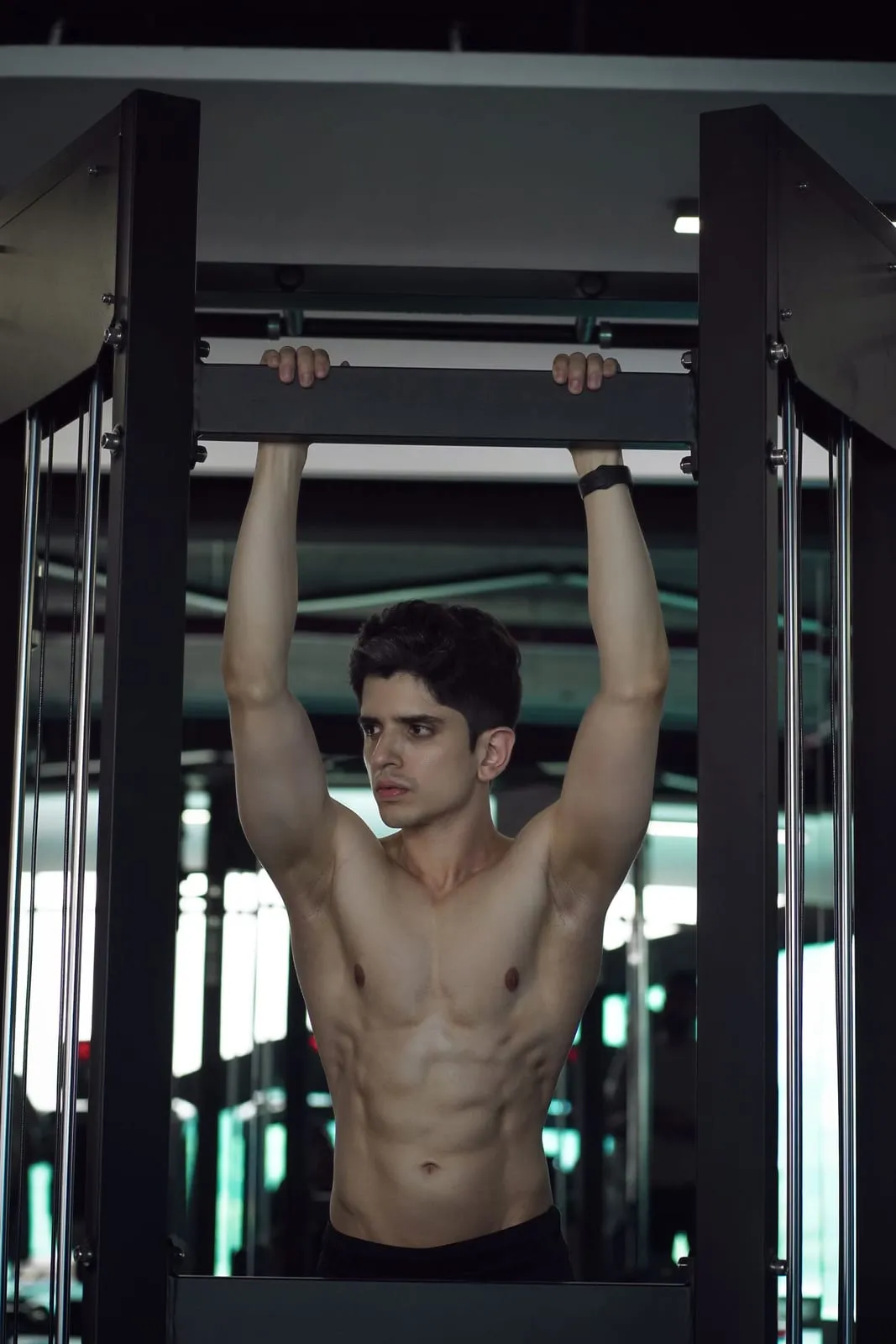 Bibek hanging from a pull-up bar, about to pull