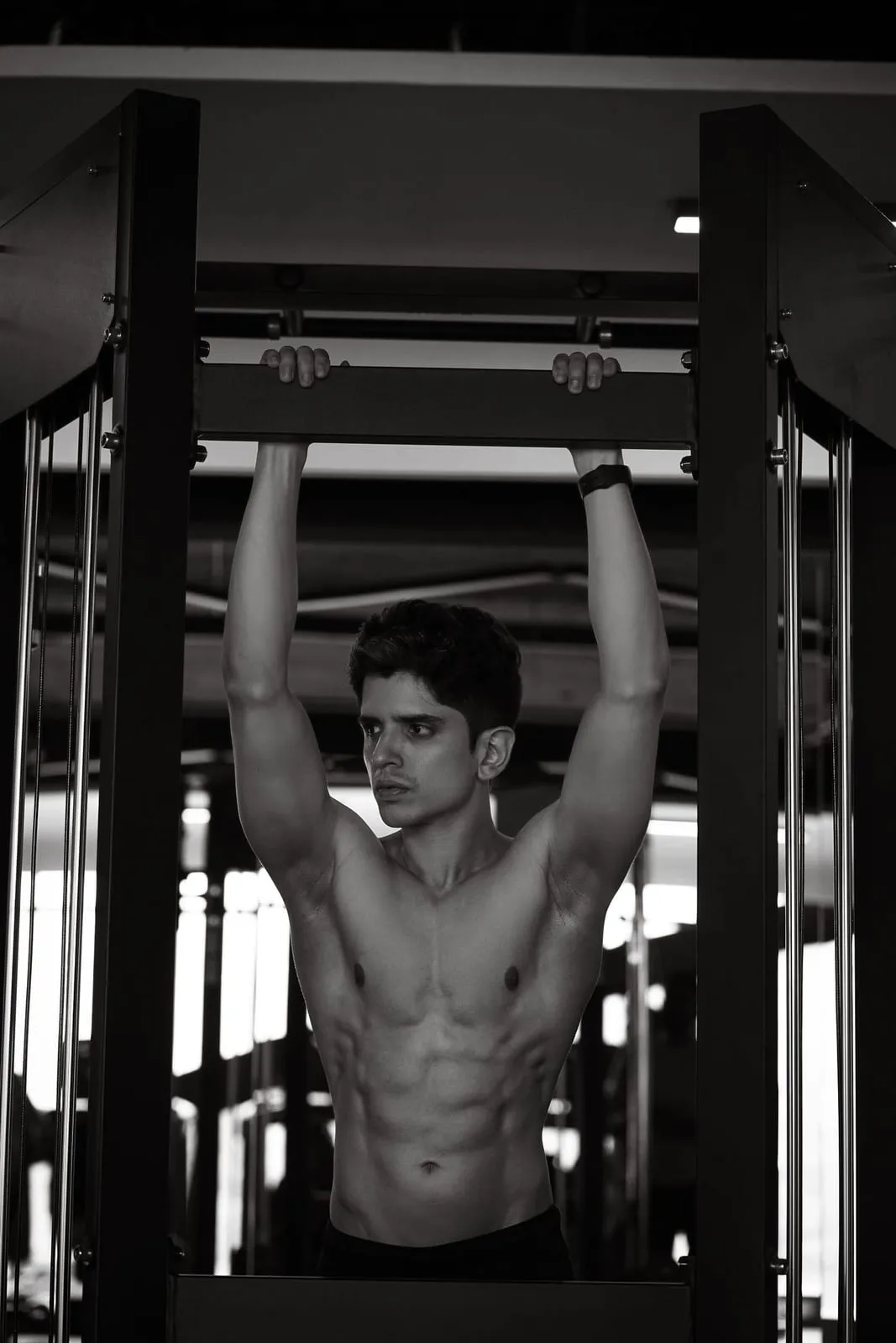 Bibek doing a pull-up, chin above the bar