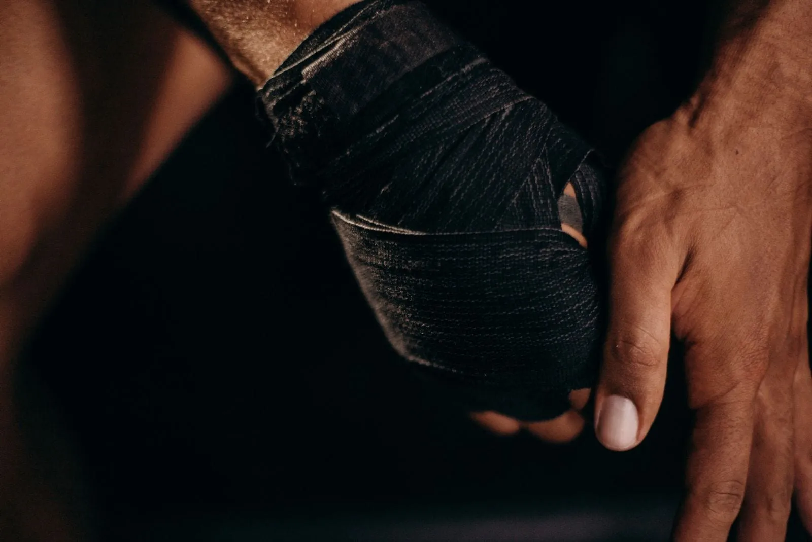 Boxer wrapping their hands before training