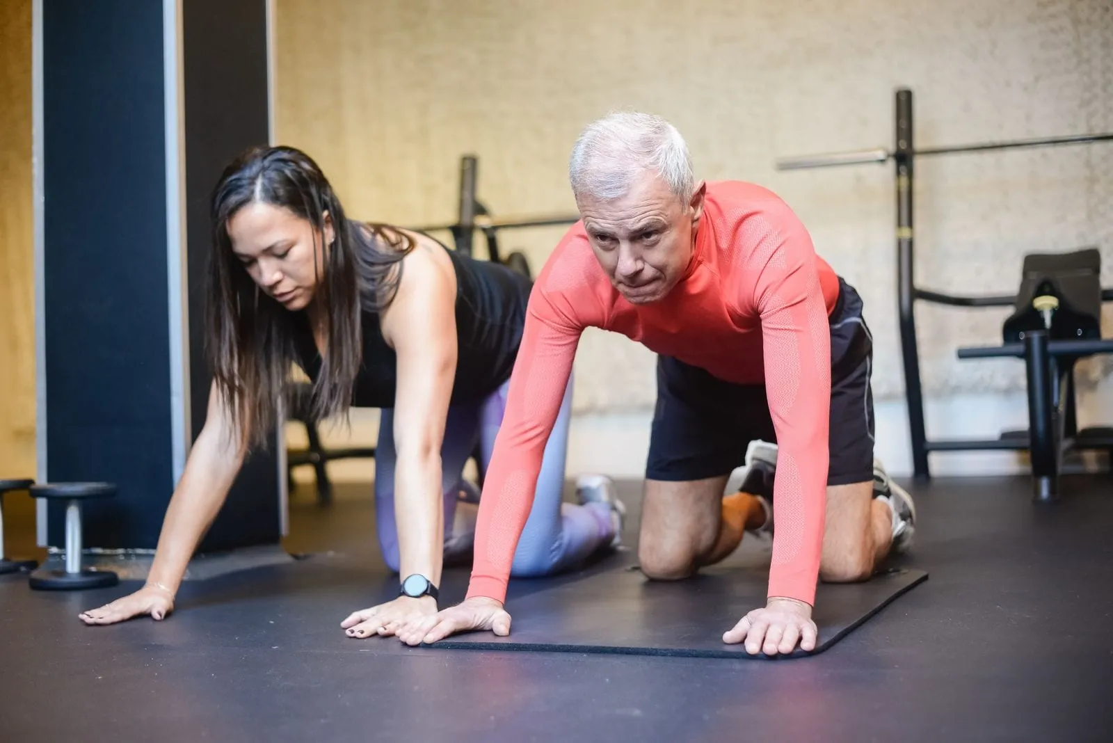 David getting up from the floor on all fours with his trainer beside him