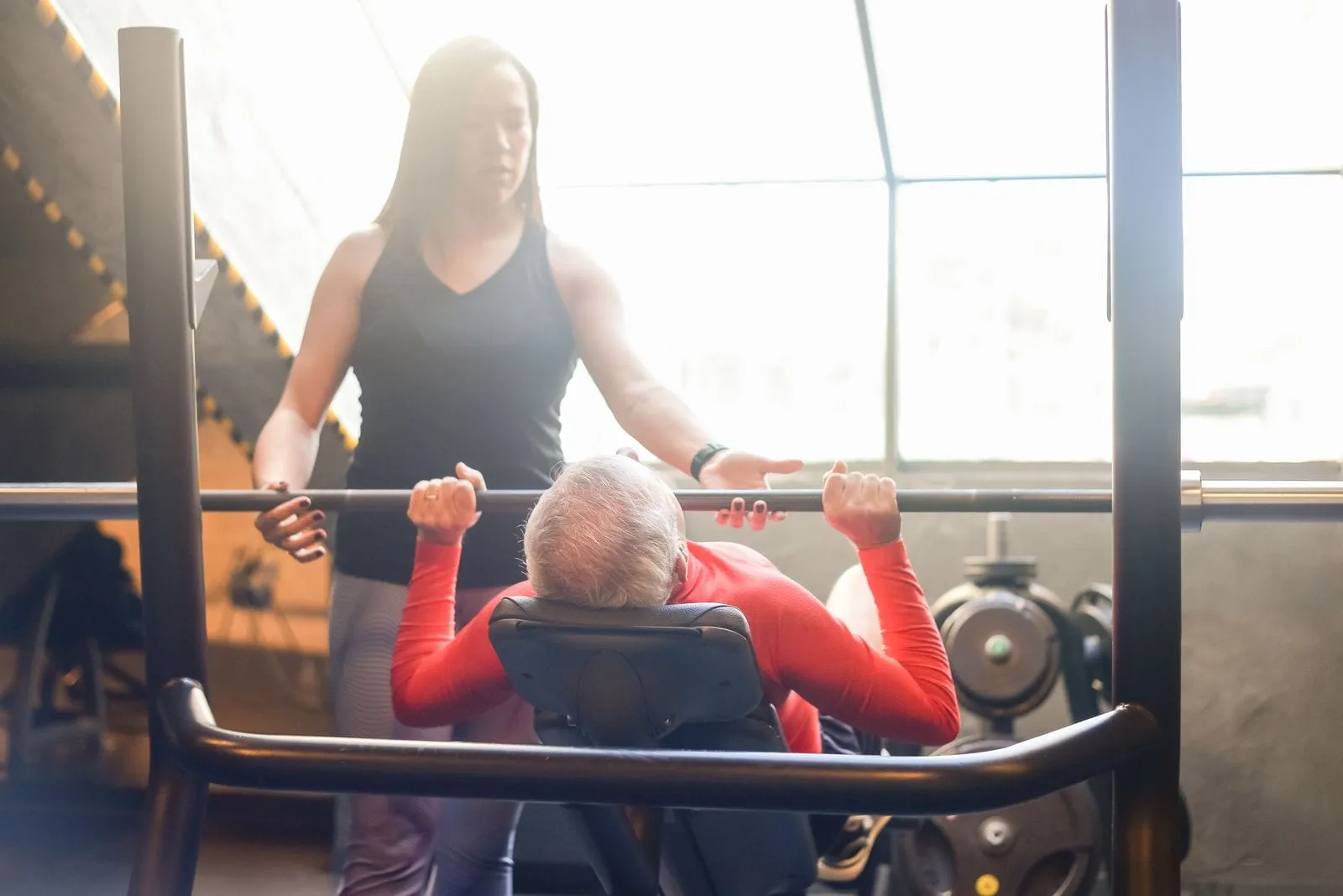 David bench pressing with a trainer spotting the bar