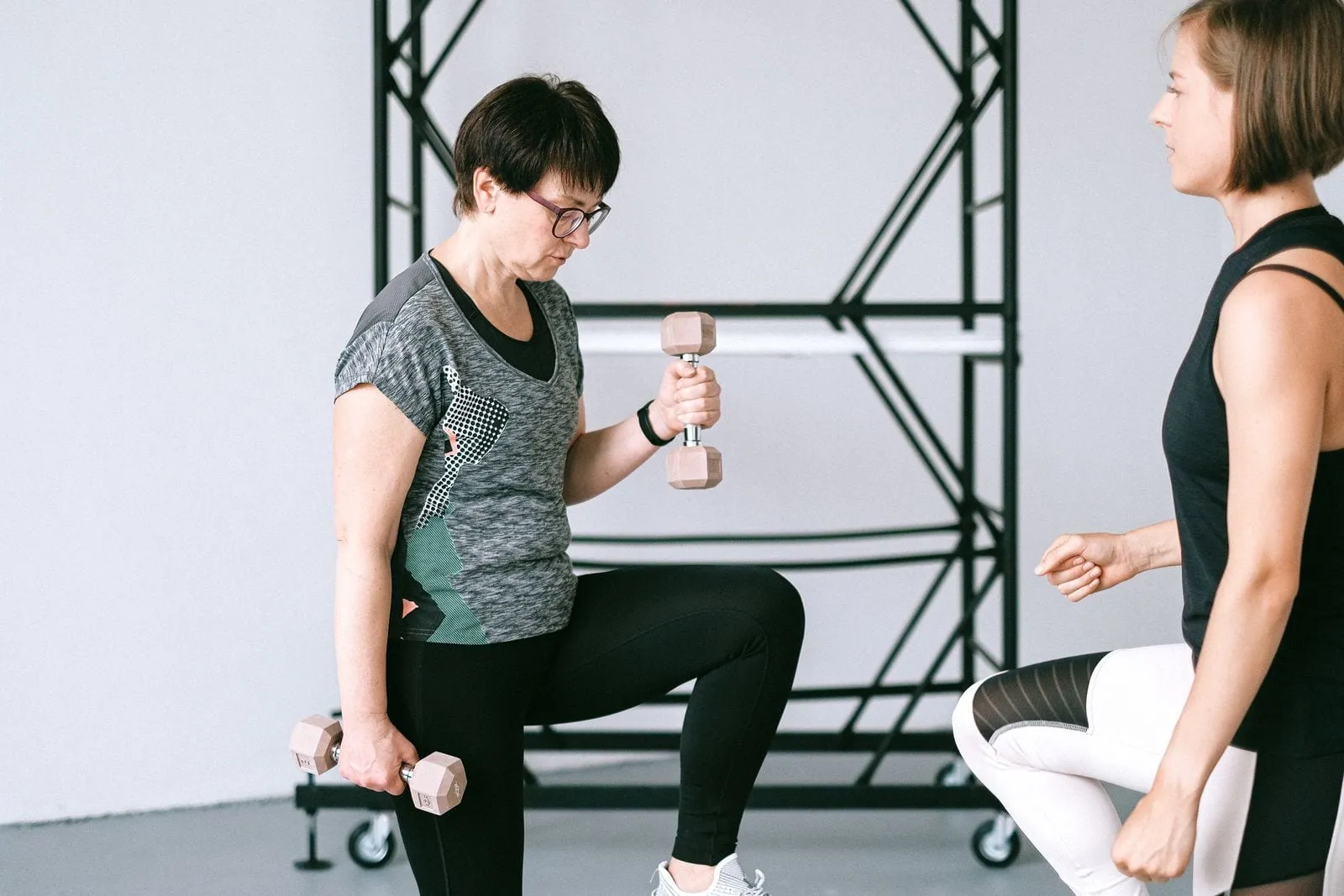 Helen in a lunge holding a dumbbell in each hand