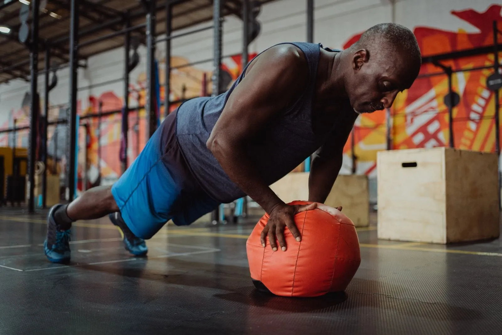 Krishna doing push-ups with his hands on a medicine ball