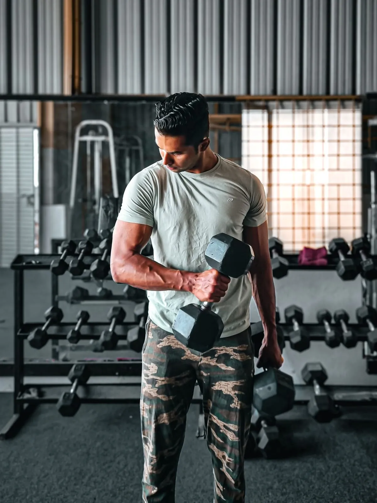 Member curling a dumbbell on the strength floor