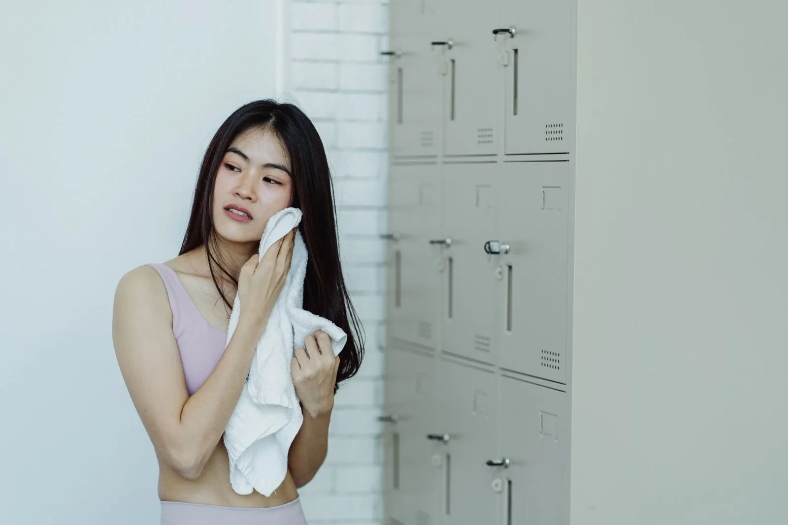 Member with a fresh towel in a clean locker room