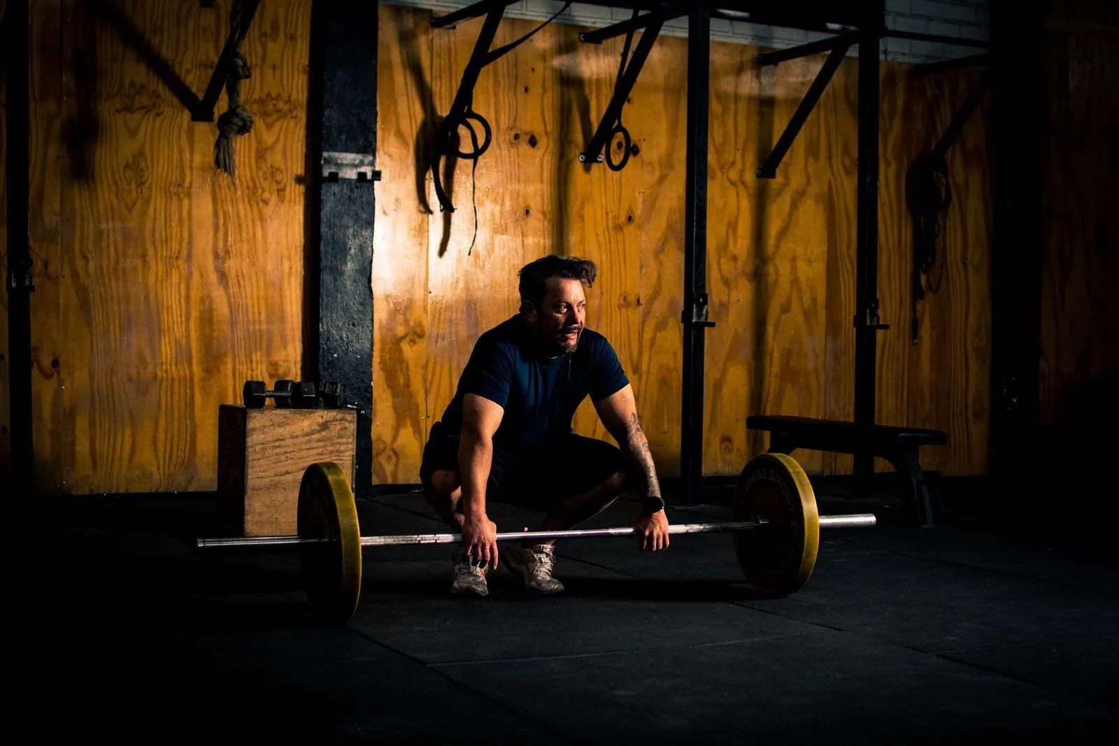 Lifter setting up a heavy deadlift on a wooden platform