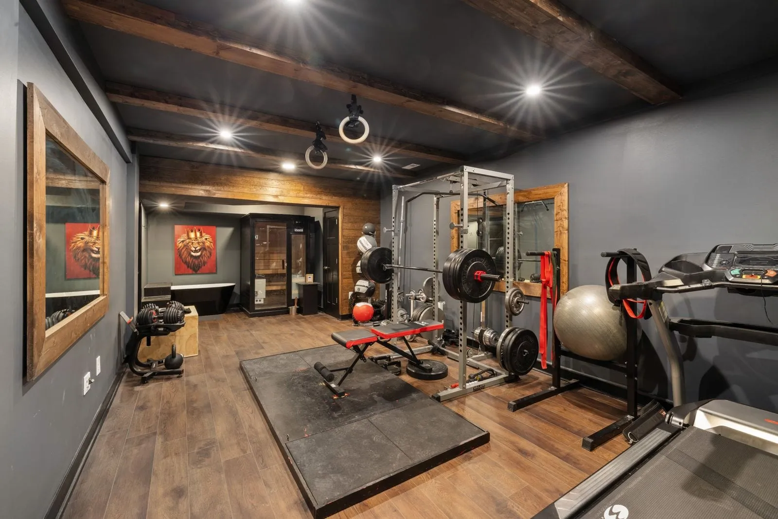 Wood-floored strength room with squat racks and free weights