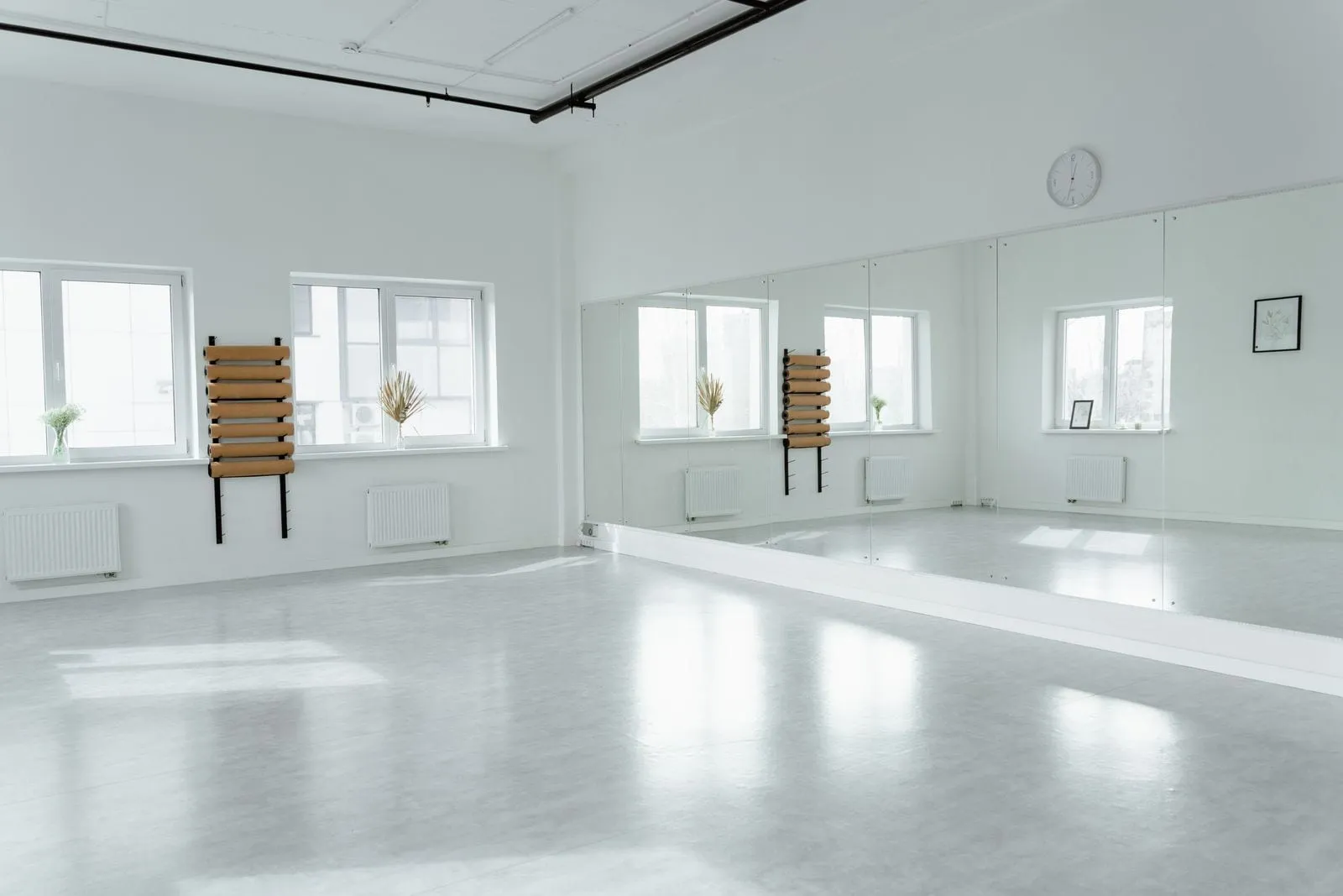 Bright dance studio with mirrors, sprung floor and tall windows