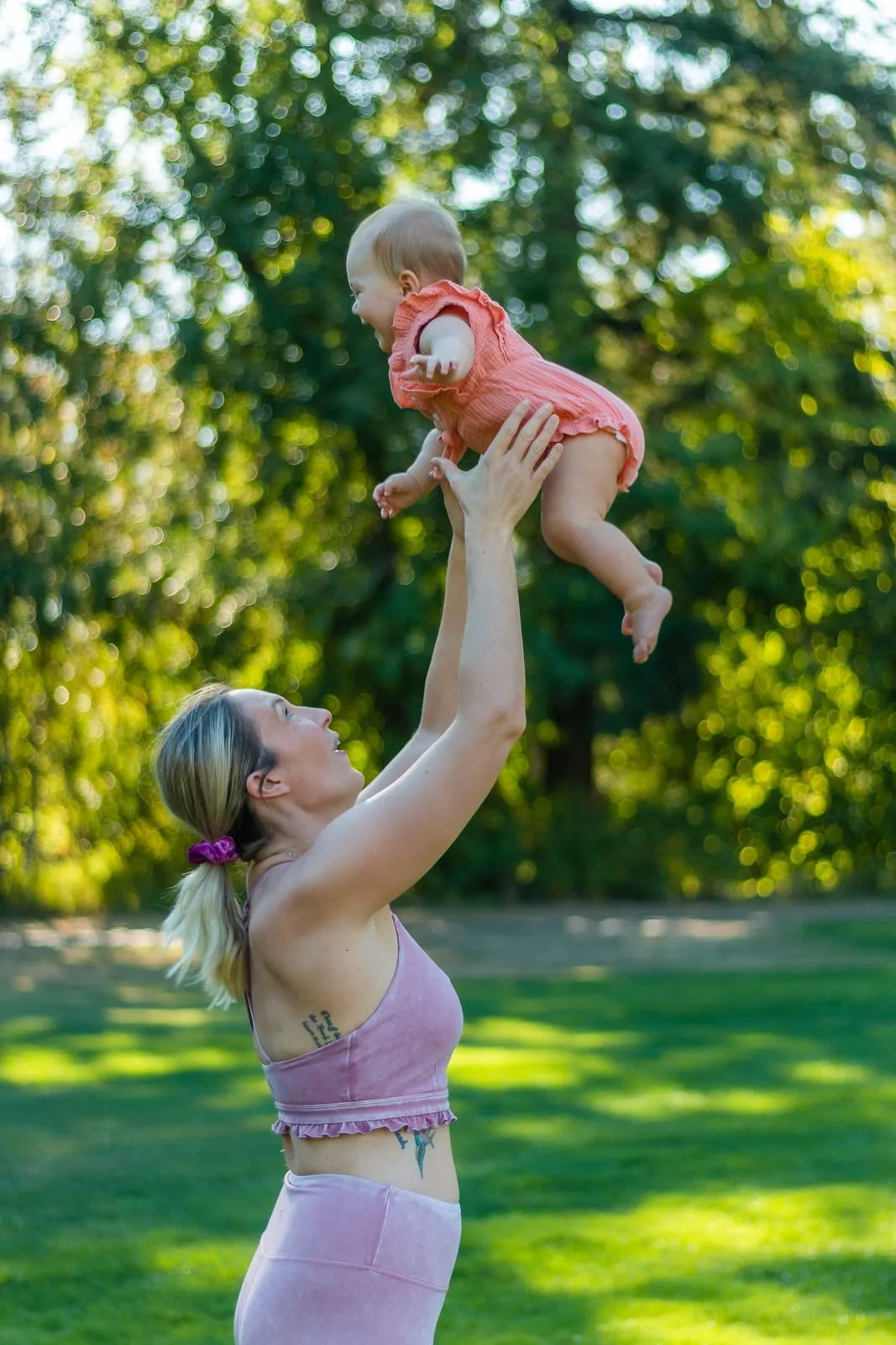 Tara lifting her laughing daughter above her head