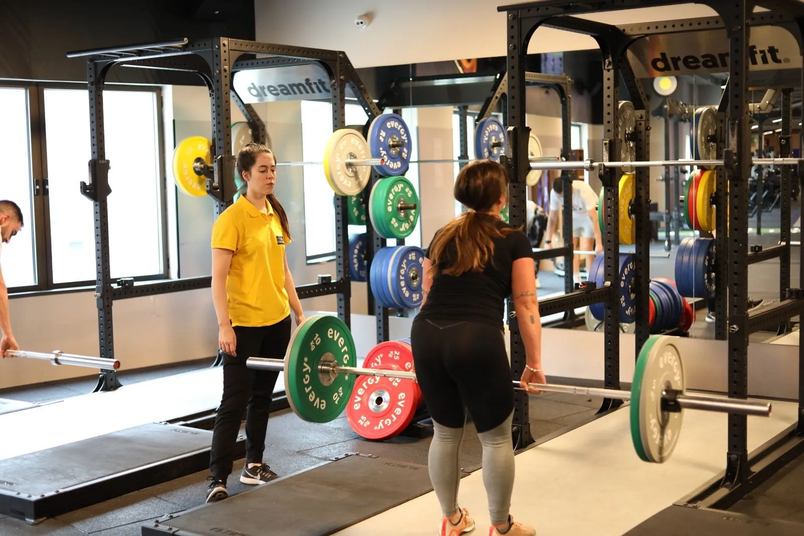 Woman lifting dumbbells on a gym floor