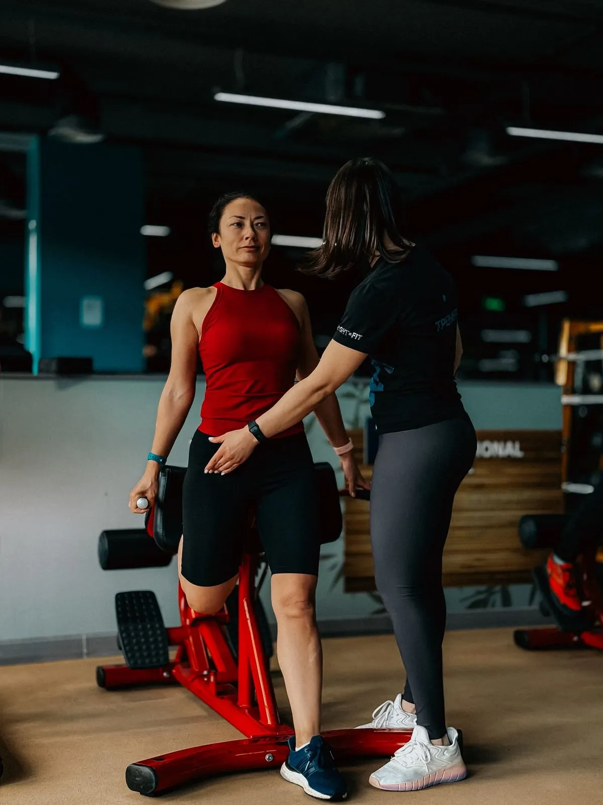 Woman trainer guiding a member on an exercise bike